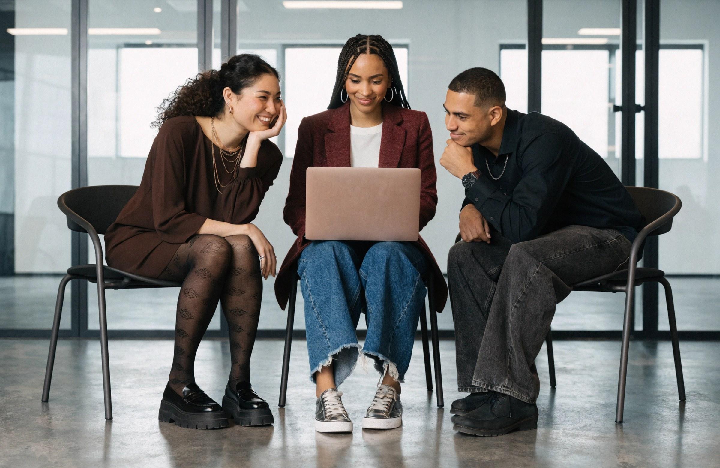 ISG teammates reviewing work together at a laptop